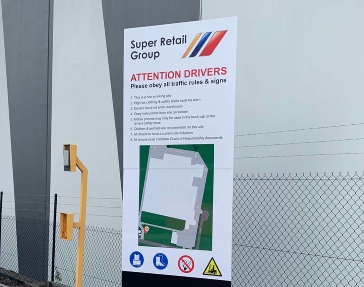 Custom safety signage displayed at warehouse entrance to guide and protect workers.