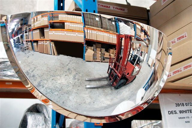 Traffic mirror inside a warehouse entrance to enhance safety and improve visibility.