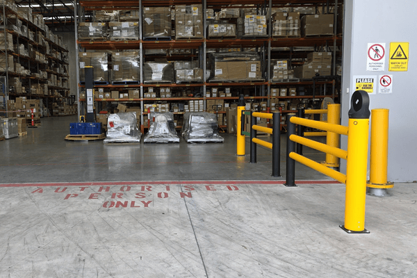 Custom safety signage displayed at warehouse entrance to guide and protect workers.